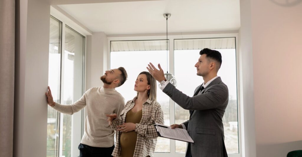 A young couple inspects a modern apartment with a real estate agent during a daytime viewing.